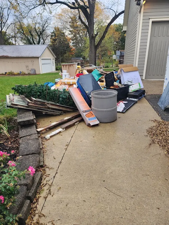 Dumpster being loaded with debris for Roofing Dumpster Rental in Valley Center